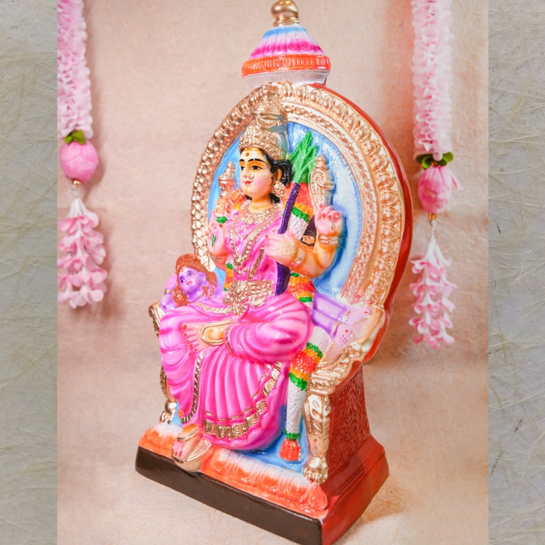 Handcrafted Navarathri Golu doll of Goddess Lalithambigai seated on a decorative throne, adorned in vibrant pink and gold accents.