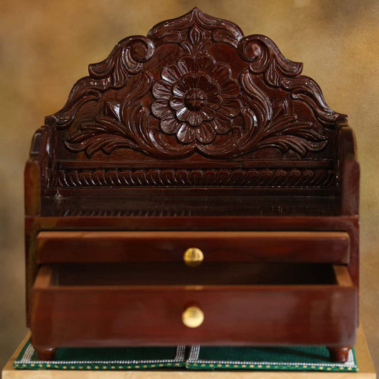 Handcrafted Teakwood Puja Mandapam with a rosewood finish, featuring intricate floral carvings and built-in storage drawers.