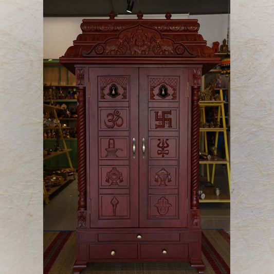 Handcrafted Puja Mandapam made from teakwood with a dark teakwood finish, featuring intricate sacred symbol carvings and storage drawers.