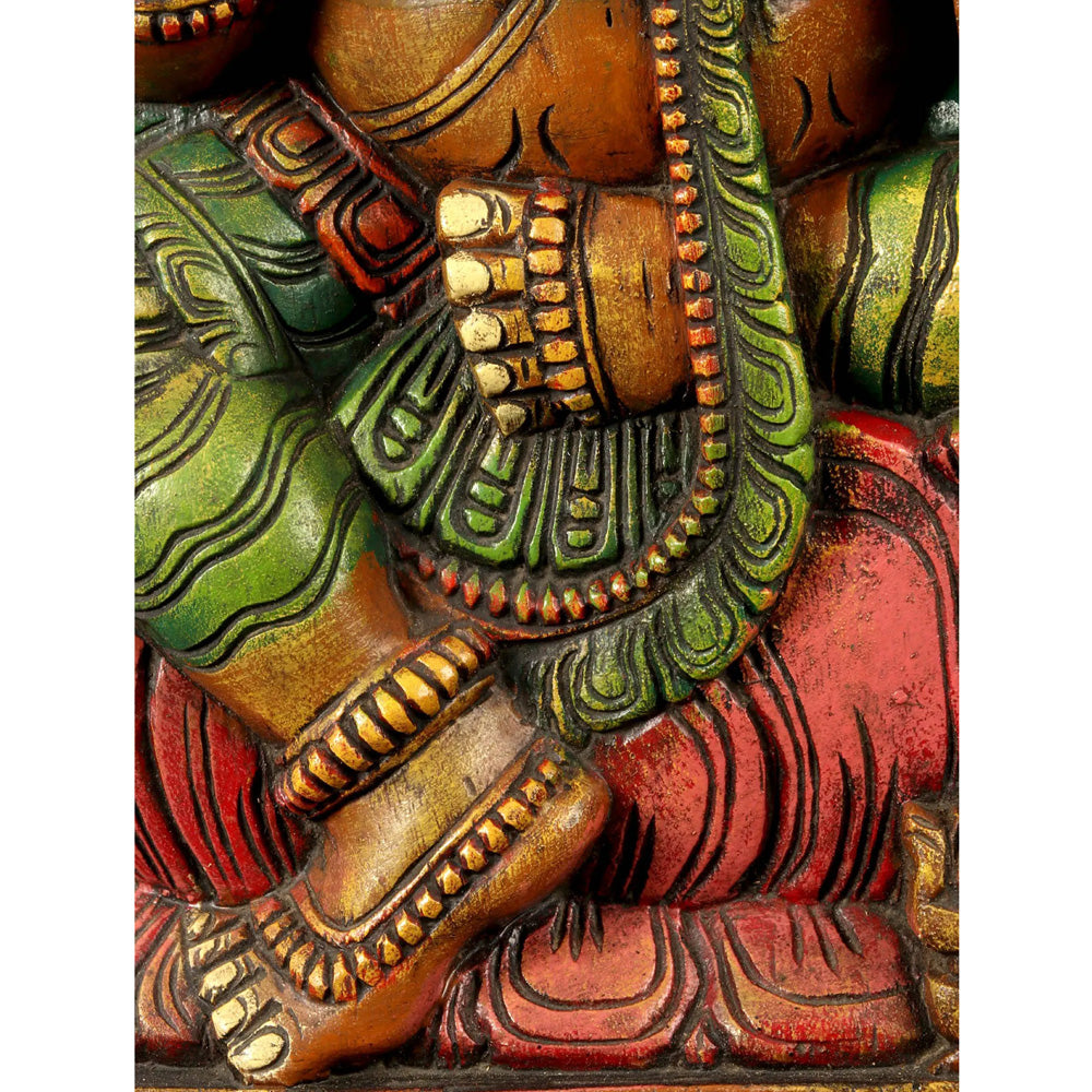 Lotus-Seated Ganesha Enshrining Prabhavali – Handcrafted Wooden Statue With Vibrant Detailing