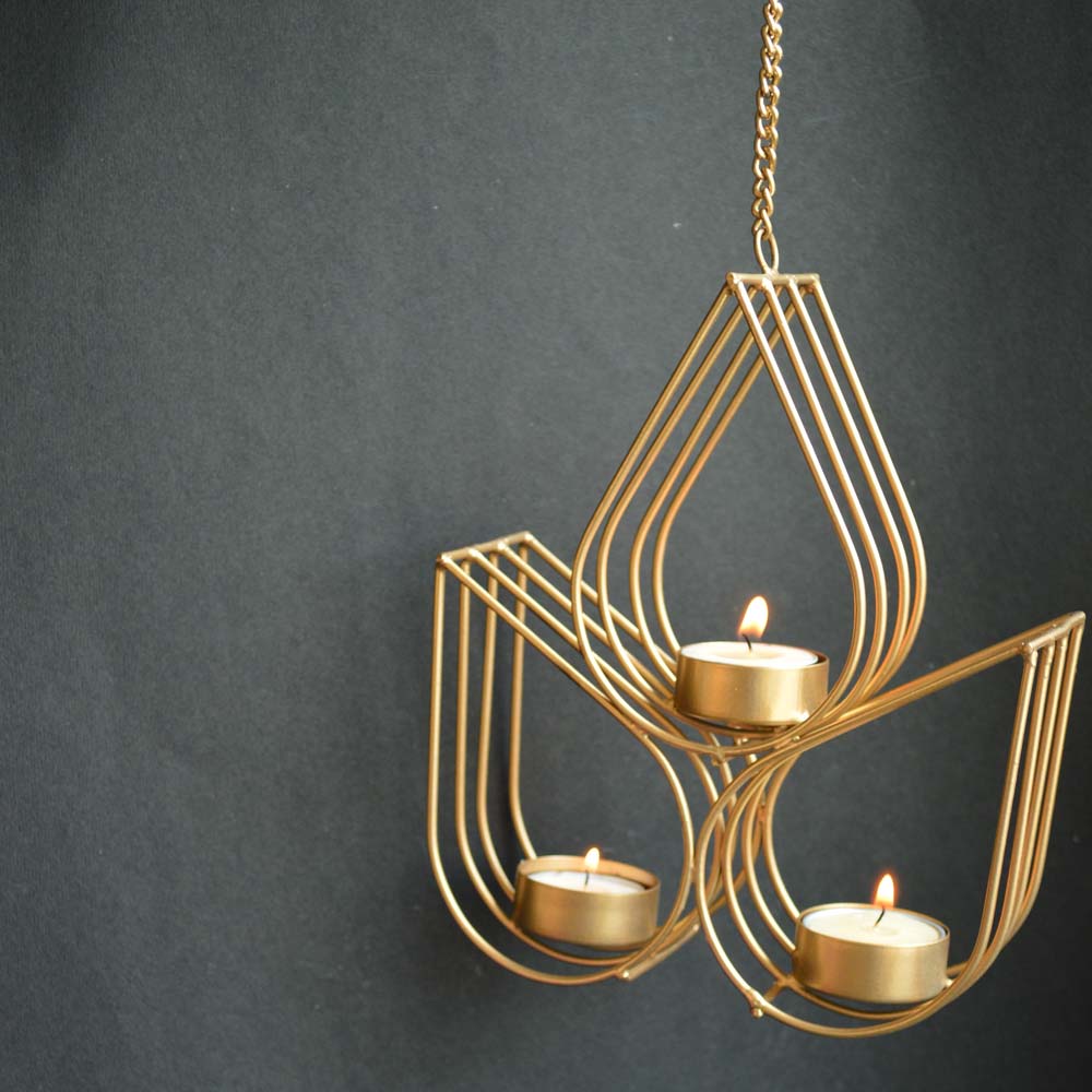 Copper-finished Lustre Hanging T-Light Holder with three symmetrical drop-shaped frames, each holding a lit T-light, suspended on a sturdy chain.