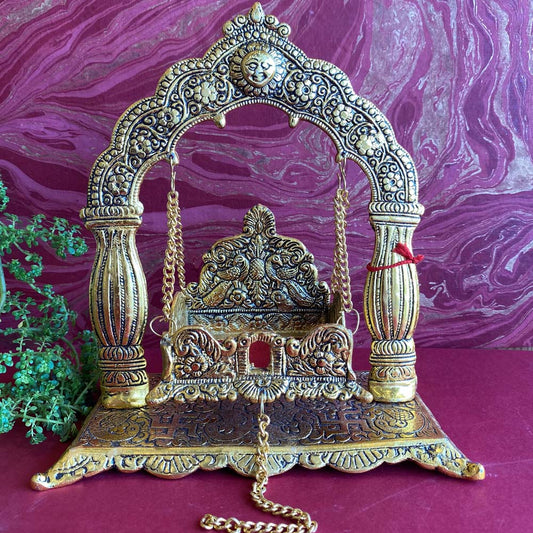 Silvery oxidised Jhoola frame with intricate carvings and golden chain, perfect for deities and home decor.