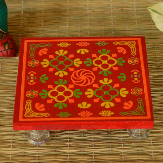 Wooden puja stool with colorful floral design and acrylic feet.