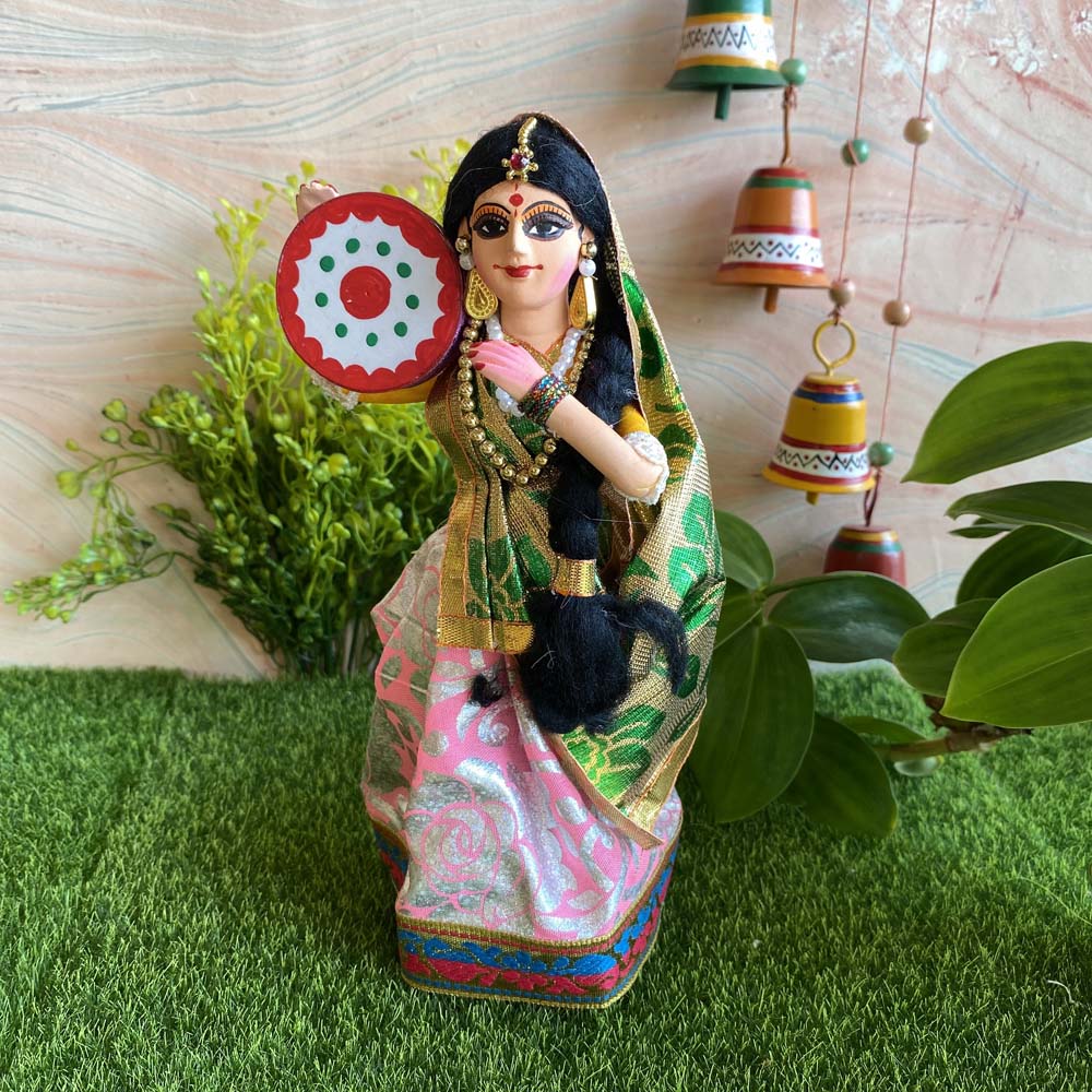 Handcrafted Navarathri costume doll of an Indian lady playing a Dapli, dressed in vibrant traditional attire with jewelry.