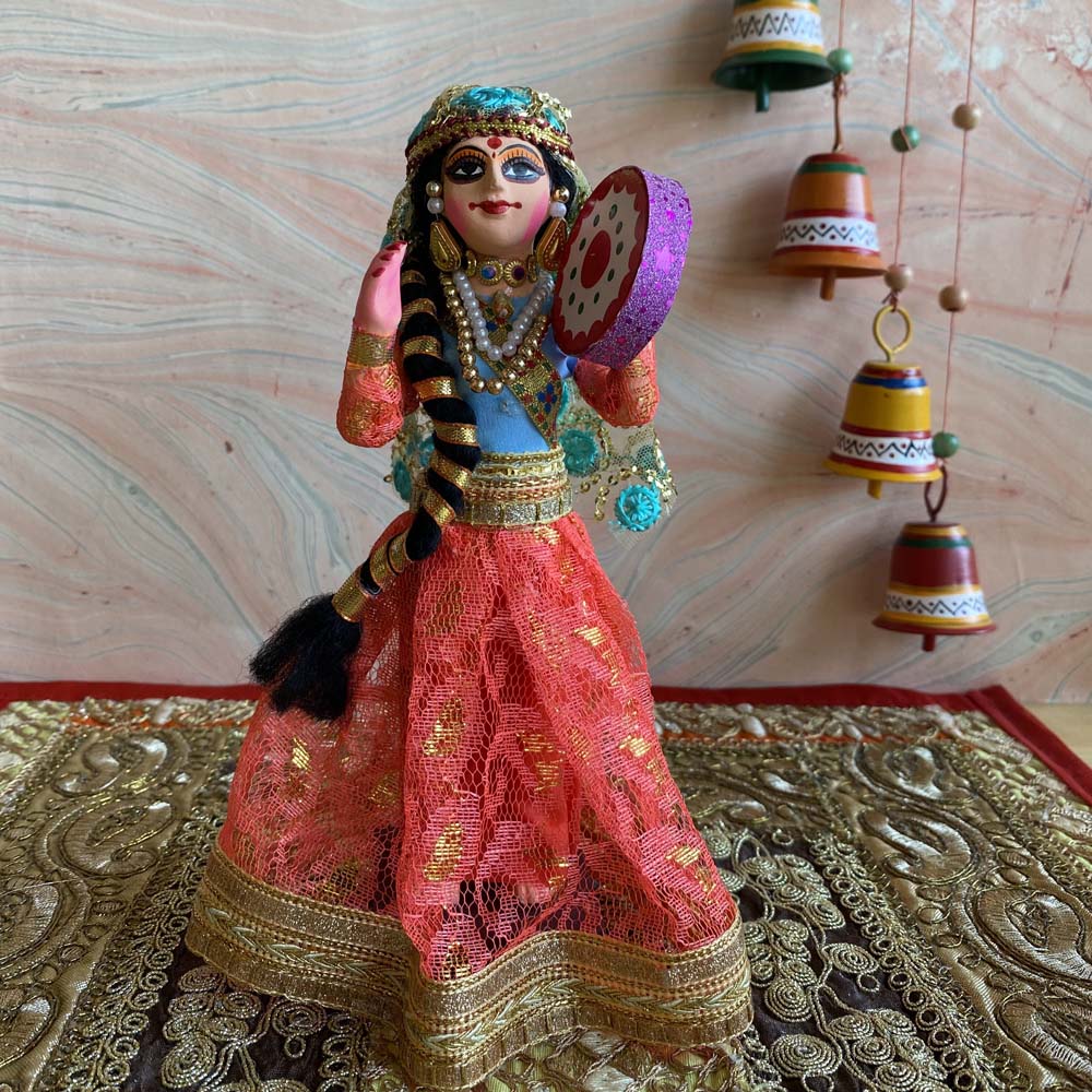 Handcrafted Navarathri costume doll of a Banjara lady playing a tambourine, dressed in vibrant traditional attire with detailed jewelry.