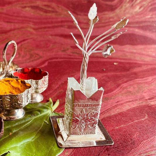 Silvery Tulasi Madam, a metal holder with a delicate tree design for the sacred Tulsi plant, perfect for pooja spaces.