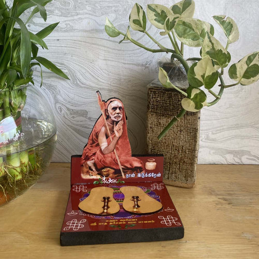 Mahaperiyava Patham L-Shape Photo Stand with copper padukas on a vibrant decorative base.