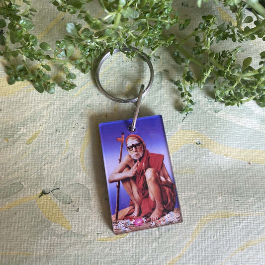 Mahaperiyava key chain featuring a vibrant acrylic image of the revered sage, perfect for spiritual keepsakes and daily use.