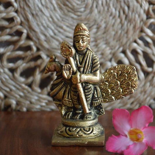 Brass statue of Lord Murugan with Vel and peacock, traditional South Indian deity sculpture.