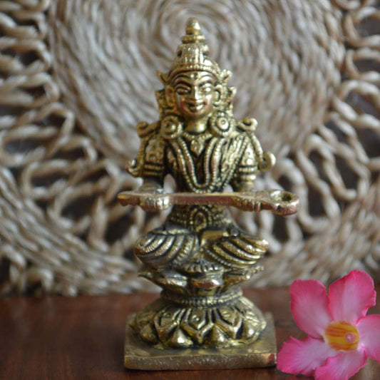 Handcrafted brass Annapoorni idol with intricate detailing, symbolizing nourishment and prosperity.