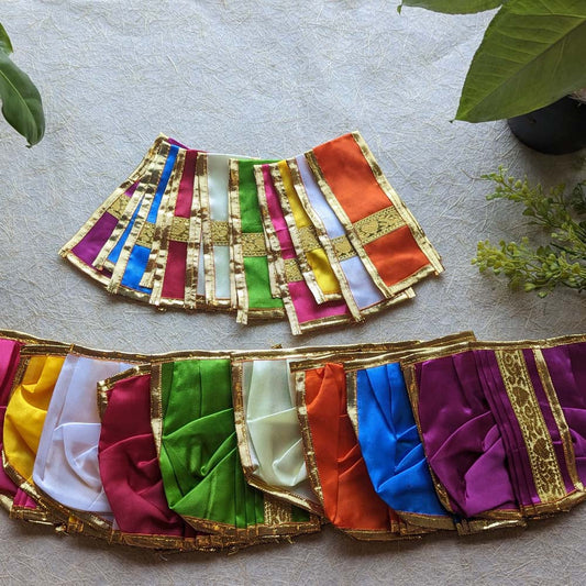 Traditional Panchagajam skirts in vibrant colors including red, orange, green, white, yellow, blue, and purple, adorned with intricate gold borders.