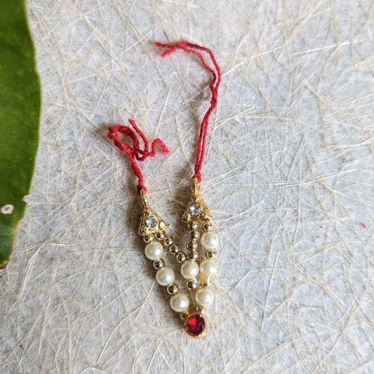 Traditional 3-inch pearl and stone mangalsutra pendant with red gemstone on red thread.