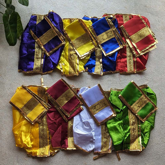 Assorted colorful Panchakacham dhoti set with golden zari borders laid out in vibrant patterns.