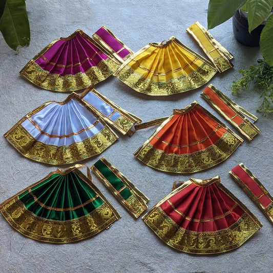 Assorted Devi skirts in vibrant colors with intricate golden zari borders, perfect for deity decorations.