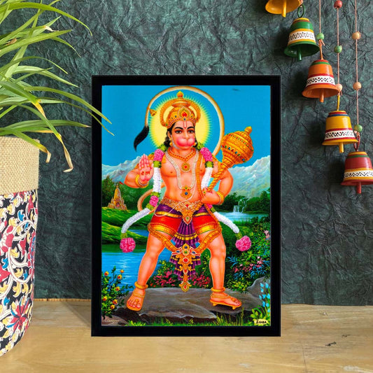 Lord Hanuman standing with his mace in a vibrant setting, blessing with one hand – spiritual framed wall décor.