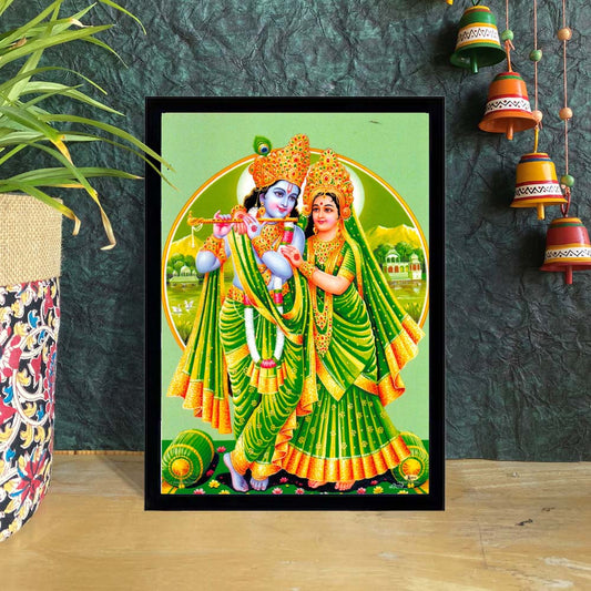 Framed art print of Radha Krishna in green attire, with Krishna playing the flute and Radha standing gracefully.