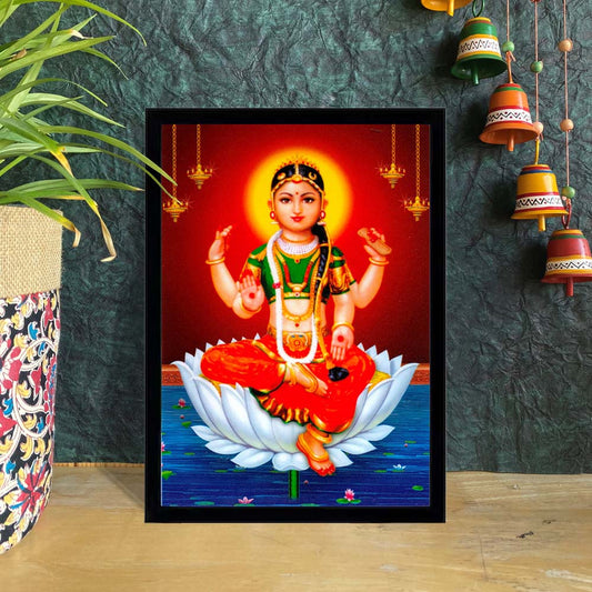 Bala Tripurasundari seated on a white lotus with a radiant red background, adorned in vibrant attire and divine ornaments.