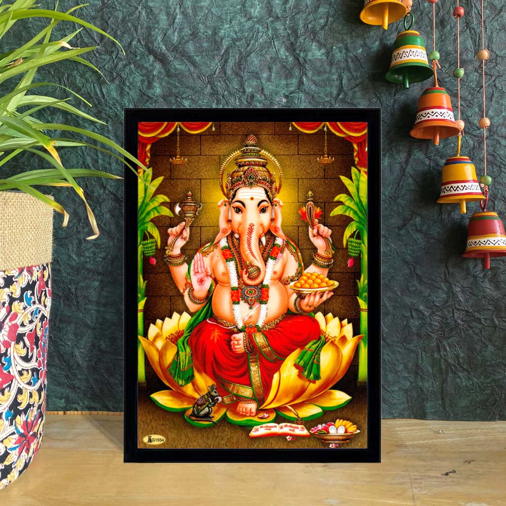 Framed Lord Ganesha artwork seated on a lotus, with traditional Indian décor in the background.