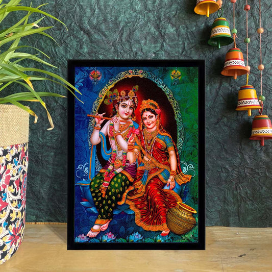 Framed art print of Radha and Krishna seated on a decorative swing with vibrant colors and intricate details.