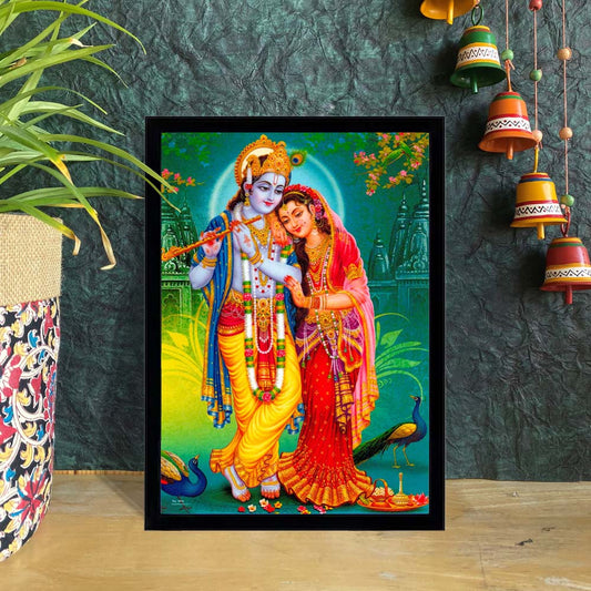 Framed art print of Radha Krishna with Krishna playing the flute and Radha leaning on him, surrounded by peacocks and temple scenery.