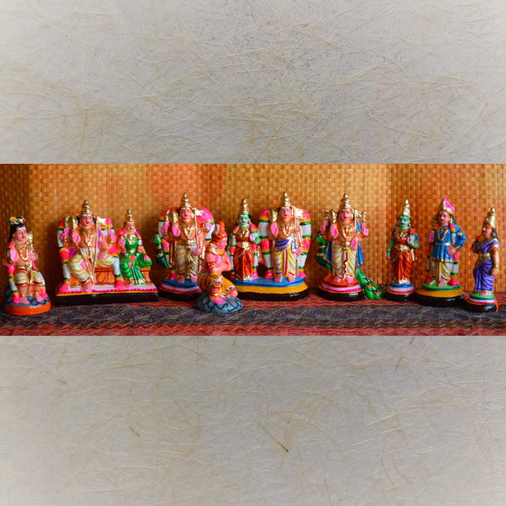 Handcrafted Navaratri Arupadai Veedu Golu doll set featuring vibrant figurines of Lord Murugan’s six abodes and associated deities, set against a decorative backdrop.