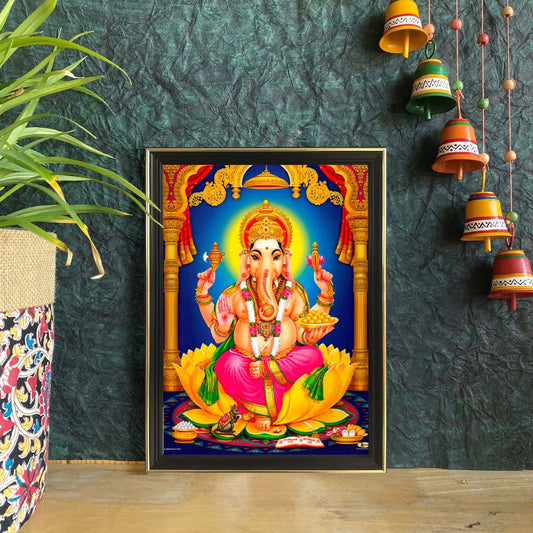 Lord Ganesha framed artwork featuring the deity seated on a golden lotus with vibrant temple décor and intricate adornments.